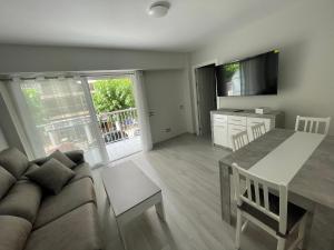 a living room with a couch and a table at Apartamento de lujo en Cullera con Aire Acondicionado y posibilidad de Parking in Cullera