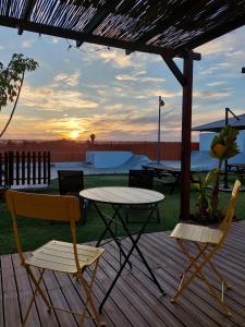 a table and chairs on a wooden deck with a table and chairs at Single Fin Conil in Conil de la Frontera