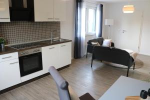 a kitchen and living room with a table and chairs at Domo Dolce Wohnapartment in Appel