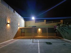 a building with a light on the side of it at The Green Villa in Ash Shāghūr