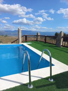 a swimming pool on the side of a house at Quinta Do Marmeiral in Mangualde