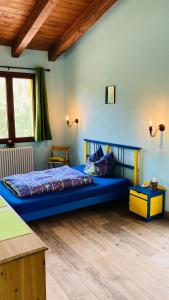 a bedroom with a large blue bed in a room at Coru & Bentu in Fluminimaggiore