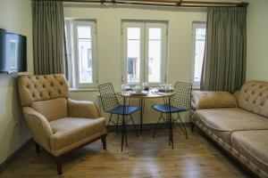 a living room with a couch and a table and chairs at Taksim Neo Pera Suites in Istanbul