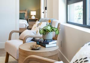 a living room with a table with books and a plant at Stoked On Revy - Family Condo in Revelstoke in Revelstoke