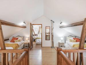 a bedroom with two beds and a mirror at John Fanner Barn - Uk37102 in Mellis