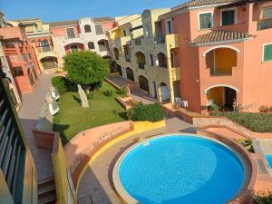 an overhead view of a swimming pool in a courtyard with buildings at Casa Ginevra in Santa Teresa Gallura