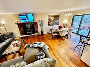 a living room with a couch and a dining room at Sauna, Games,Grill, View,Lake,Pool,TVs in Albrightsville