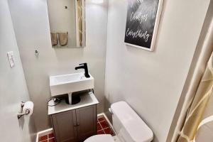 a bathroom with a white toilet and a sink at Sauna, Games,Grill, View,Lake,Pool,TVs in Albrightsville +52 photos