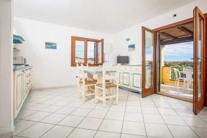 a kitchen with a table and a view of the ocean at Casa Ginevra in Santa Teresa Gallura