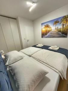 a bedroom with a bed with a painting on the wall at Luxury and Spa App F in Makarska