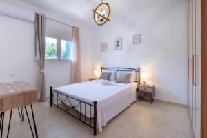 a bedroom with a large bed and a window at VillaBlu Apartments in Asgourou