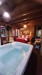a large bath tub in a room with a bed at CABANA PARAÍSO in Santo Amaro da Imperatriz +51 photos