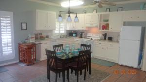 a kitchen with a table and chairs and a refrigerator at Joyful Quarters - Beautiful Spacious 1 Bedroom Apt in Houston