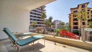 a balcony with a chair and a view of a building at One Medano 8B in Cabo San Lucas