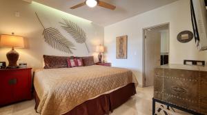 a bedroom with a bed and a ceiling fan at One Medano 8B in Cabo San Lucas +31 photos