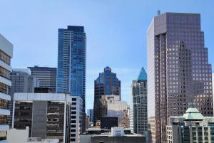 a view of a city skyline with tall buildings at AZUR Legacy Collection Hotel in Vancouver