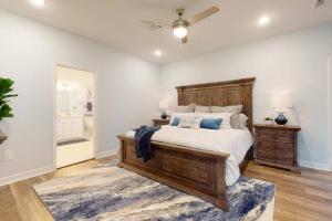 a bedroom with a large wooden bed and a rug at Let's get Beachy! in Bolivar Peninsula