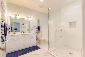 a bathroom with a shower and a toilet and a sink at Let's get Beachy! in Bolivar Peninsula +23 photos