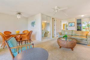 a living room with a table and a couch at Beautiful Princeville Garden Condo with lots of Amenities C2108 in Princeville
