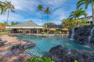 a pool at a resort with a waterfall at Beautiful Princeville Garden Condo with lots of Amenities C2108 in Princeville
