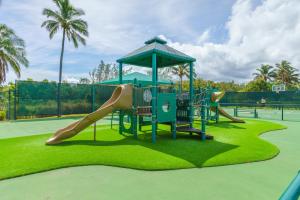 a playground with a slide on a tennis court at Beautiful Princeville Garden Condo with lots of Amenities C2108 in Princeville