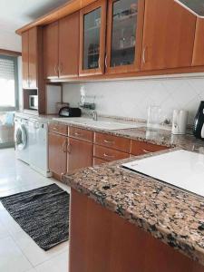 a kitchen with a counter top and a dishwasher at Apartamento Alcochete in Alcochete