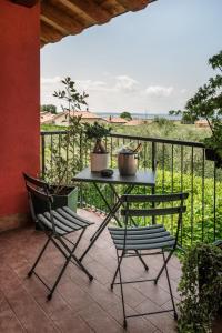 a table and two chairs on a patio with a fence at Bardolino Suite in Bardolino +18 photos