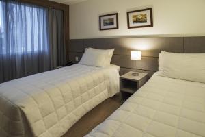 Ένα ή περισσότερα κρεβάτια σε δωμάτιο στο Hotel Laghetto Moinhos
