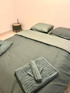 a bed with two towels on top of it at Villa La caroline 2 in Montpellier +51 photos