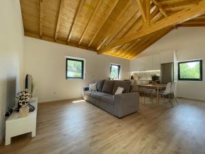 a living room with a couch and a table at Teixeira Home - Gerês in Geres