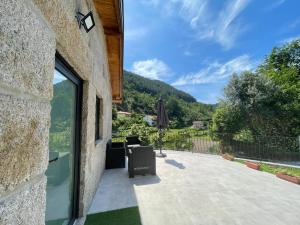 a patio with a view of the mountains from a house at Teixeira Home - Gerês in Geres