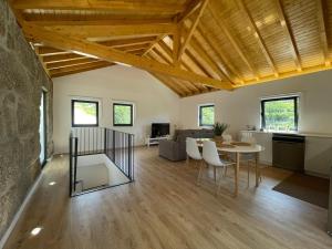 a living room with a table and a dining room at Teixeira Home - Gerês in Geres