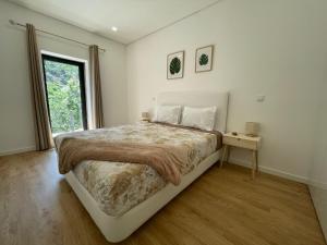 Ένα ή περισσότερα κρεβάτια σε δωμάτιο στο Teixeira Home - Gerês