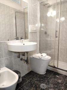 a bathroom with a sink and a shower and a toilet at HOTEL MILAZZO in Rome