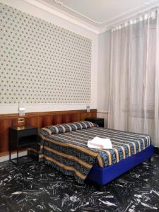 Een bed of bedden in een kamer bij HOTEL MILAZZO