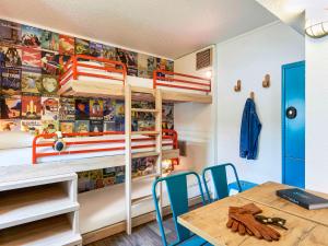 a room with bunk beds with a table and chairs at hotelF1 Paris Porte de Châtillon in Paris