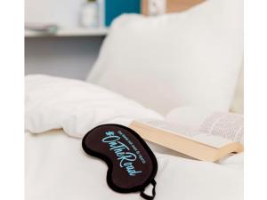 a guitar key on a bed with a book at hotelF1 Paris Porte de Châtillon in Paris