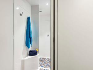 a pivot door in a white room with a blue umbrella at hotelF1 Paris Porte de Châtillon in Paris