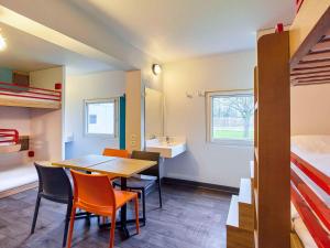 a room with a table and chairs and a bed at hotelF1 Paris Porte de Châtillon in Paris