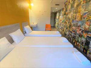 a hospital room with white beds and pictures on the wall at hotelF1 Paris Porte de Châtillon in Paris