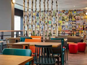 a dining room with tables and colorful chairs at hotelF1 Paris Porte de Châtillon in Paris