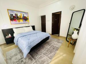 a bedroom with a bed and a large mirror at House Ire in Abuja