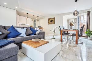 a living room with a couch and a table at Hello Alicante Apartamentos in Alicante