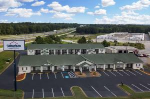 an aerial view of a hotel with a parking lot at Suburban Studios in Spartanburg
