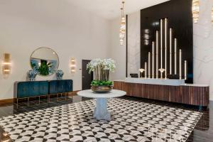 um lobby com uma mesa com flores em Cambria Hotel Detroit Downtown em Detroit