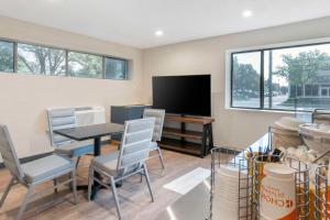 a living room with a table and chairs and a tv at Comfort Inn in Kansas City