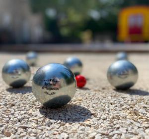 a group of balls sitting on the ground at La Ferme D'Augustin in Saint-Tropez