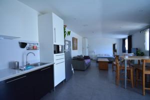 a kitchen and living room with a sink and a table at Grand studio indépendant avec jardin in Goussainville