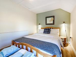 a bedroom with a large bed in a room at Studio Cottage in Treffynnon 