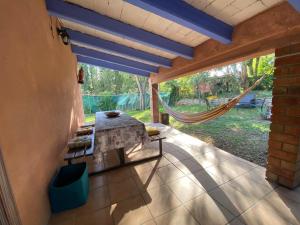 a room with a hammock on a patio at Casa junto al bosque in Bescanó